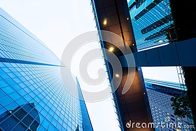 looking up view in financial district, the silhouettes of skyscrapers city reflect dramatic blue sky, sun lights in Tokyo, Japan Stock Photo