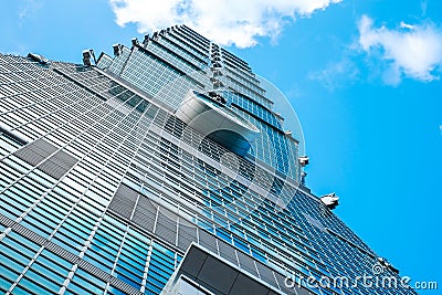 Looking up view of Taipei 101, the landmark of Taiwan, reflect blue sky and sun lights Stock Photo