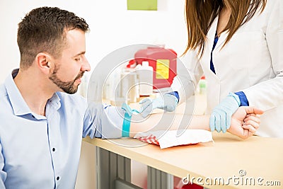 Looking for a vein before drawing blood Stock Photo