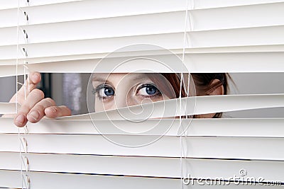 Looking through the window blinds Stock Photo