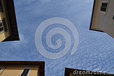 Four part of the houses with wonderful shapes of the clouds on the sky Stock Photo