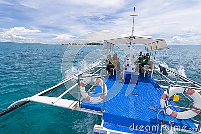 Local tourists ride a bangka or outrigger boat designed for tourism purposes. Editorial Stock Photo