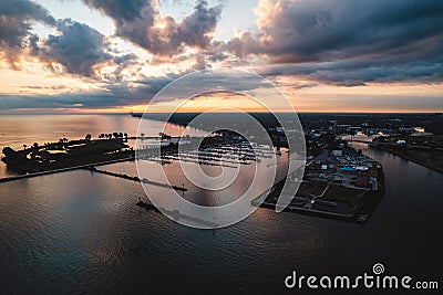 Lorain harbor with the sun rising to the east, with clouds and reflections in the water Stock Photo