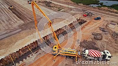 Lorry crane, truck concrete mixer and other machinery working on a road construction site in Warsaw, Poland. Drone top Stock Photo