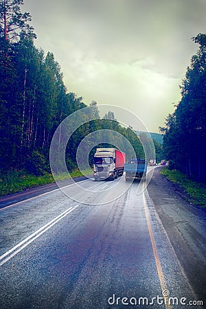 lorry on highway-delivery of goods in bad weather threat. photo from the cab of a large truck on top Editorial Stock Photo