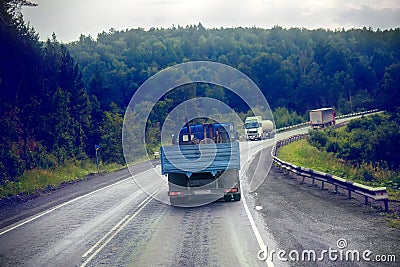 lorry on highway-delivery of goods in bad weather threat. photo from the cab of a large truck on top Editorial Stock Photo