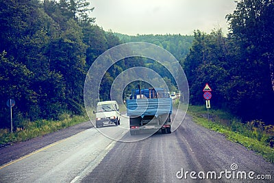 Lorry on highway-delivery of goods in bad weather threat. photo from the cab of a large truck on top Editorial Stock Photo