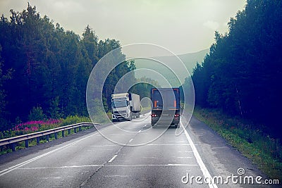 lorry on highway-delivery of goods in bad weather threat. photo from the cab of a large truck on top Editorial Stock Photo