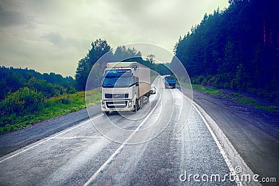 lorry on highway-delivery of goods in bad weather threat. photo from the cab of a large truck on top Editorial Stock Photo