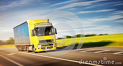 Lorry moving on sunny evening Stock Photo