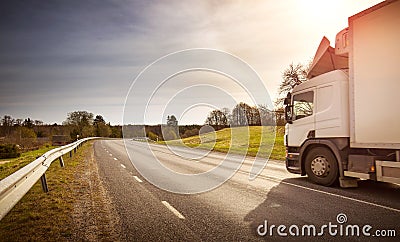 Lorry moving on sunny evening Stock Photo