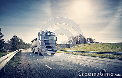 Lorry moving on sunny evening Stock Photo