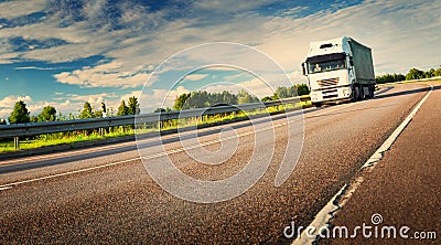 Lorry moving on sunny evening Stock Photo