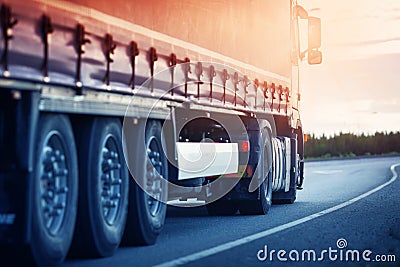 Lorry moving on sunny evening Stock Photo