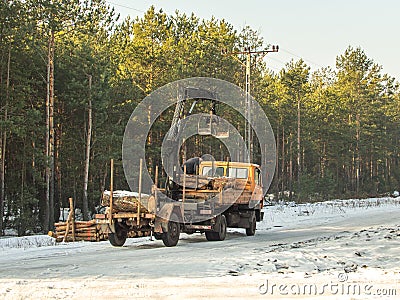 A lorry with a trailer and a small crane Editorial Stock Photo