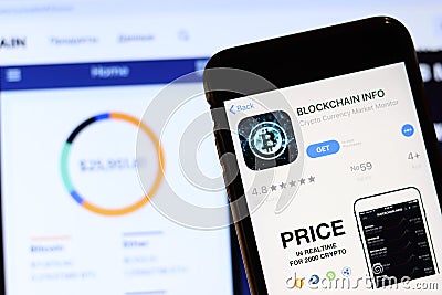 Los Angeles, California, USA - 28 November 2019: Blockchain info app icon on mobile phone screen with logo on laptop on blurry Editorial Stock Photo