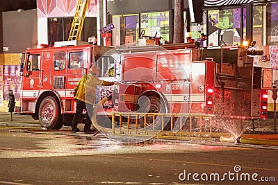 Fireman attending fire engine pump at Sunset Blvd. fire Editorial Stock Photo