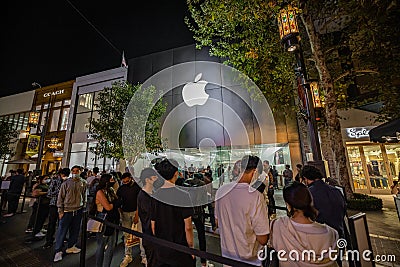 Group of people waiting in line for Apple iPhone 13 Editorial Stock Photo