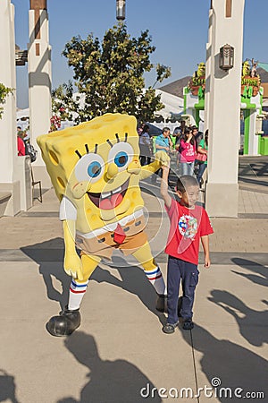 Los Angeles-USA, October, 3: Cartoon Character Sponge Bob Playing with Little Asian Boy at Universal Studios in Los Angeles, Cali Editorial Stock Photo