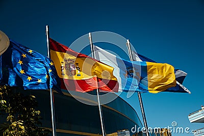 Los Cristianos, Tenerife Spain. 12/18/2022 Flags in the sun, the flag of Spain, the European Union, the flag of Tenerife and the Editorial Stock Photo