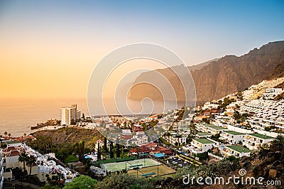 Los Gigantes resort town on Tenerife at sunset. Giant rock formations Acantilados de Los Gigantes as beautiful tourist Stock Photo