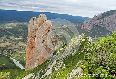 Los Mallos de Riglos unusual shaped red conglomerate rock formation in Spain Stock Photo