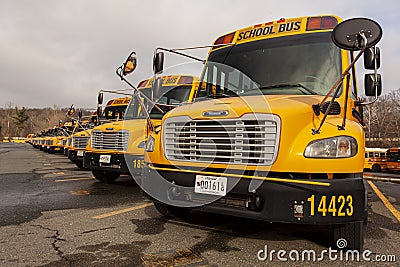 lose up selective focus frontal view of a school bus fleet at a parking lot. Editorial Stock Photo
