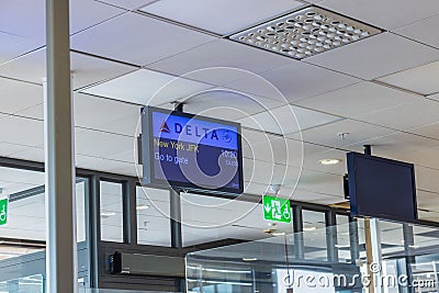 ?lose-up view of Delta airline information display at airport gate with departure information for New York. Editorial Stock Photo