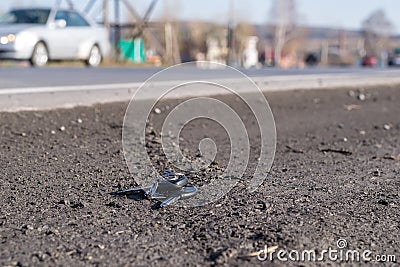 Lost bunch of keys lying on the side of the road near the asphalt pavement Stock Photo