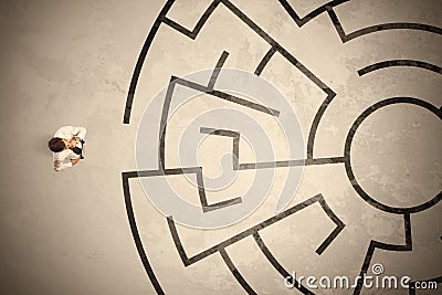 Lost business man looking for a way in circular labyrinth Stock Photo