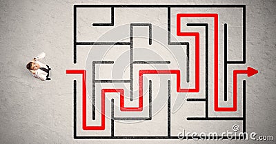 Lost businessman found the way in maze with red arrow Stock Photo