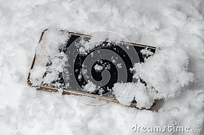 Lost cell phone is in the snow Stock Photo