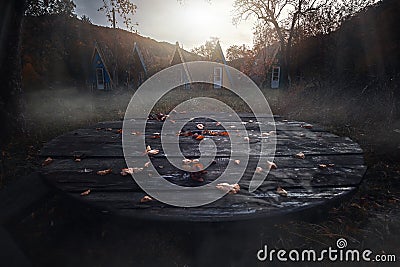 Lost place. Empty table. Abandoned resort. Rain and wind, flying leaves. Lonely houses. Fog among the trees. Forgotten Stock Photo