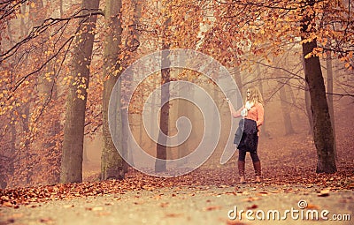 Lost woman foggy autumn park searching direction. Stock Photo