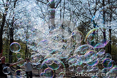 A lot of big soap bubbles that a person lets in a park, on a street in Berlin, near the Reichstag Editorial Stock Photo