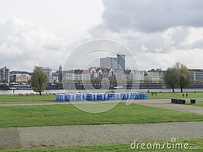 Blue bio toilets on the green embankment of the river Editorial Stock Photo