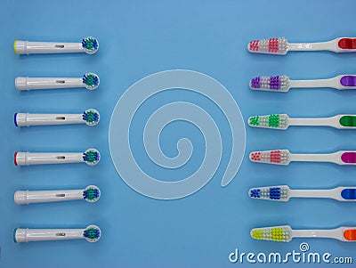 A lot of classic and electric toothbrushes lie on a pastel blue background with copy space. Top view. Flat lay Stock Photo