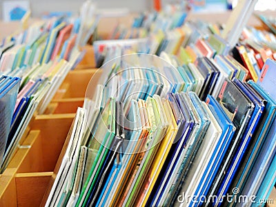 A lot of colorful children`s books standing on the public library shelf Stock Photo