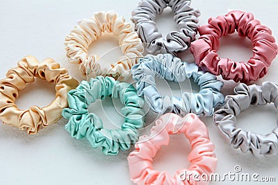 Lot of Colorful silk Scrunchies on white. Flat lay Hairdressing tools and accessories. Hair Scrunchies, Elastic HairBands, Bobble Stock Photo