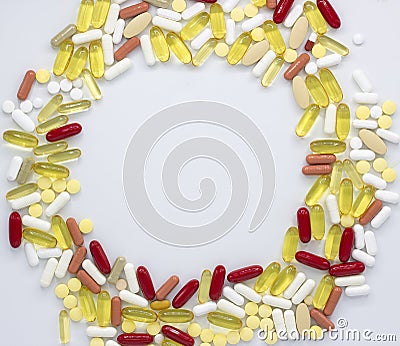 A lot of colorful vitamins and pills arranged in a circle on white background,image Stock Photo