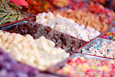 A lot of colors gummy, jelly, toffee, fudge, caramel and chocolate candies are selling in shop. Assortment of multicolored sweets Stock Photo