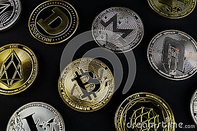 A lot of cryptocurrency coins lie on a dark surface Editorial Stock Photo