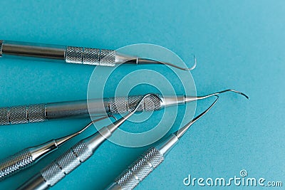 Lot of dental periodontal scalers on blue background. Stock Photo