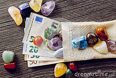 Lot of different color and type semi precious stones with euro money bank notes. Stock Photo