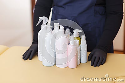 A lot of different cosmetic products for personal care. hands of the master of depilation Stock Photo