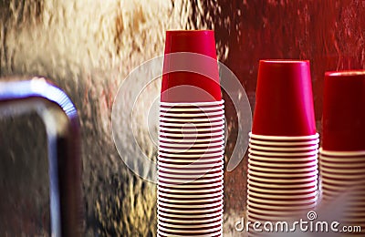 Lot of drinking paper coffee cups in piles on the background of a waterfall. Stack of disposable coffee cup, selective focus Stock Photo