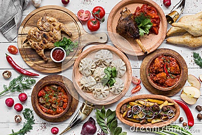 A lot of food on the wooden table. Georgian cuisine. Top view. Flat lay . Khinkali and Georgian dishes Stock Photo