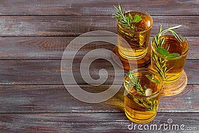 A lot of glasses of lemonade with cold tea and rosemary Stock Photo