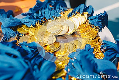A lot of gold medals on silver plate Stock Photo