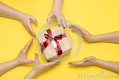 lot of hands reach for a gift with an inscription happy birthday, the concept of greed, the desire to snatch Stock Photo